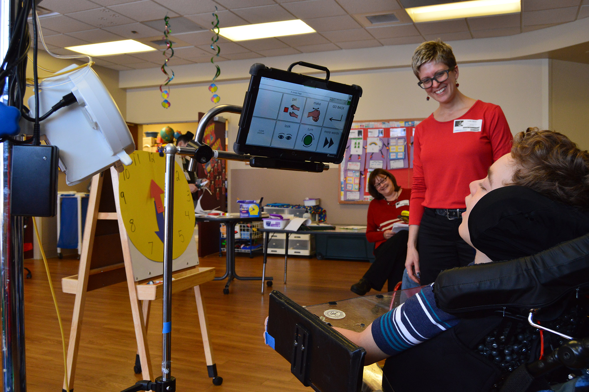 A student in a wheel chair with the universal core on an iPad mounted above him.